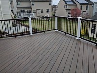 <b>Trex Transcend Spiced Rum Deck Boards in a Diagonal Pattern with Trex composite railing in matching Spiced Rum with white composite posts and black aluminum balusters</b>